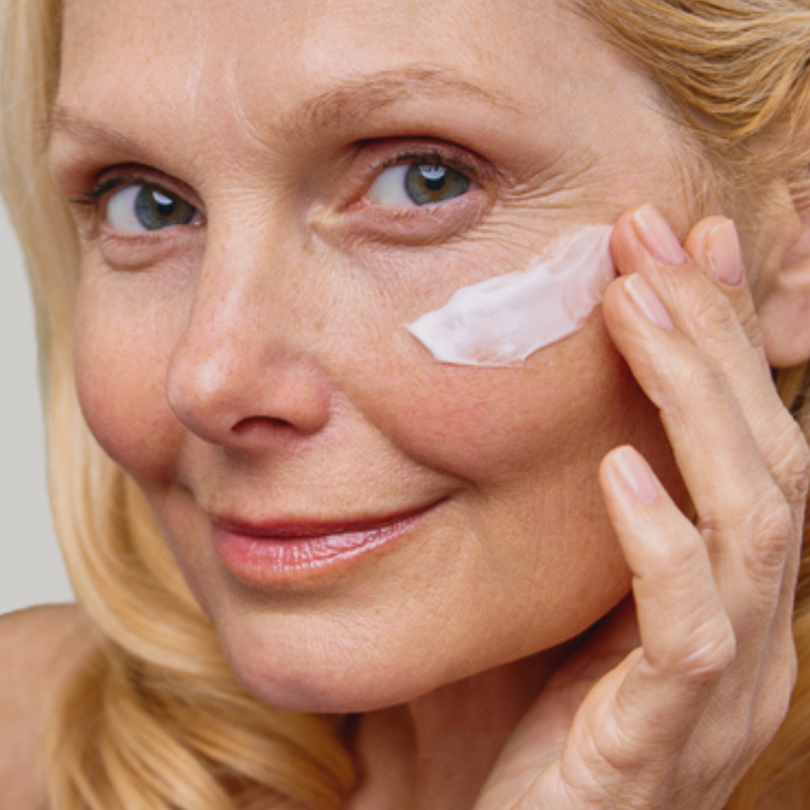 Woman applying skin treatment